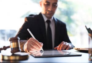 Businessman Signing Electronic Legal Document On Digital Tablet