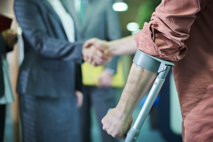 Injured man shaking hands with his personal injury lawyer